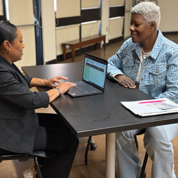 applicant sitting at a table consulting with a housing advisor