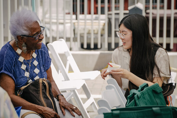 older lady and younger woman sitting and talking