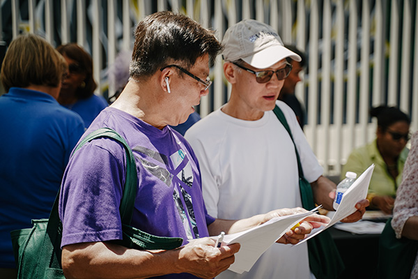Two mean looking at pamphlets