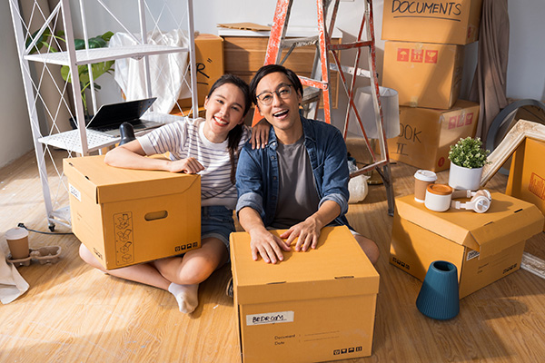 Portrait of happy Asian couple in love moving in new home