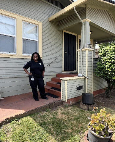person standing in front of their house.