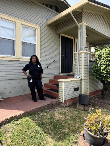 person standing in front of their house.