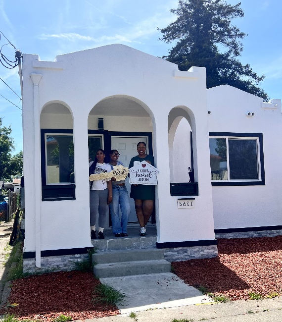 people standing in front of a house