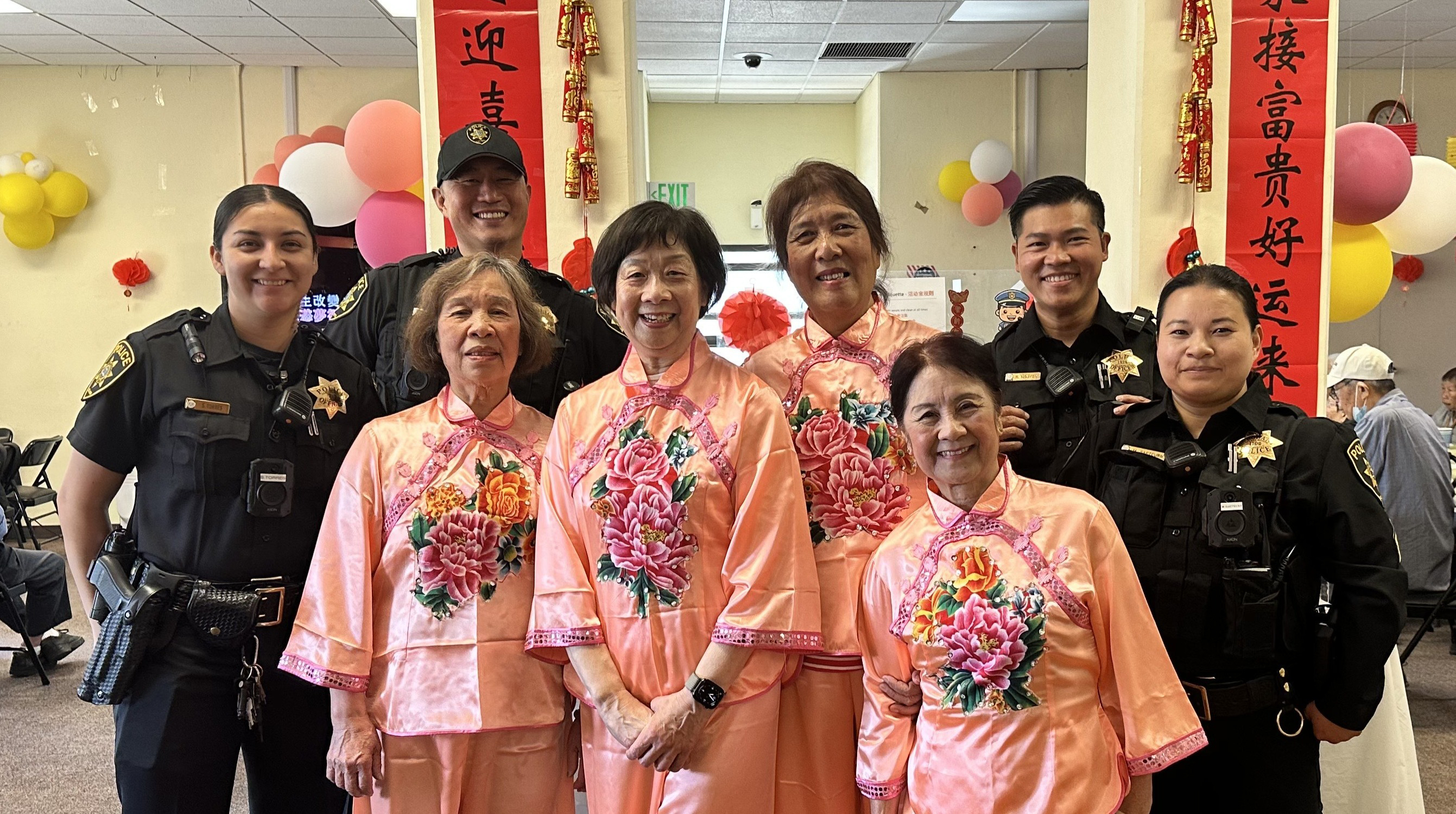 A group of people standing with several police smiling
