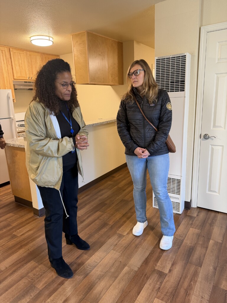 Assemblywoman Buffy Wicks speaks with Oakland Housing Authority Executive Director Patricia Wells during a site tour in Oakland on Dec. 11.