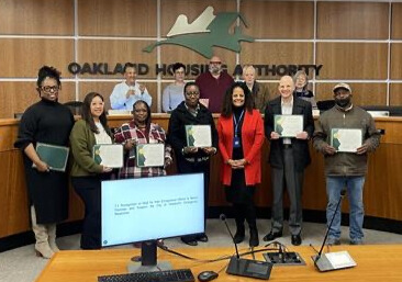 OHA members stand with Director Patricia Wells to receive their commendations.