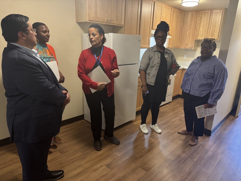 Sen. Jesse Arreguín tours a renovated apartment kitchen with Oakland Housing Authority staff.