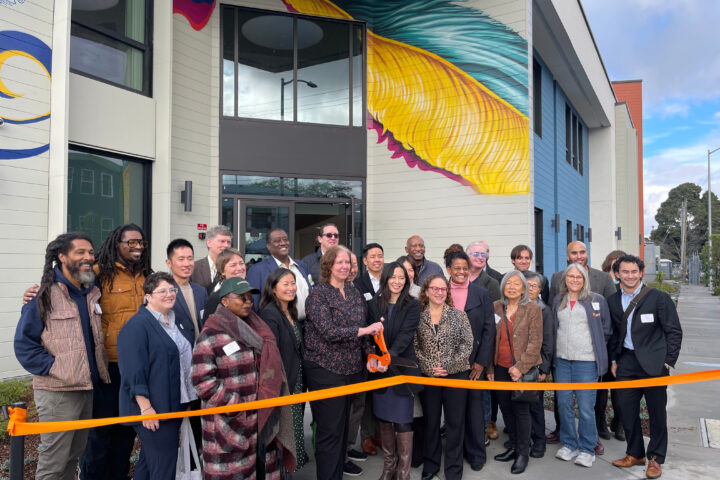 Community leaders and housing partners celebrate the ribbon cutting for The Phoenix affordable housing community in West Oakland.