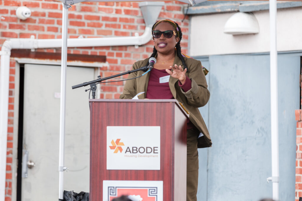 Oakland Housing Authority Chief Impact Officer Dominica Henderson speaks at a podium during the 34th & San Pablo affordable housing groundbreaking ceremony in West Oakland.